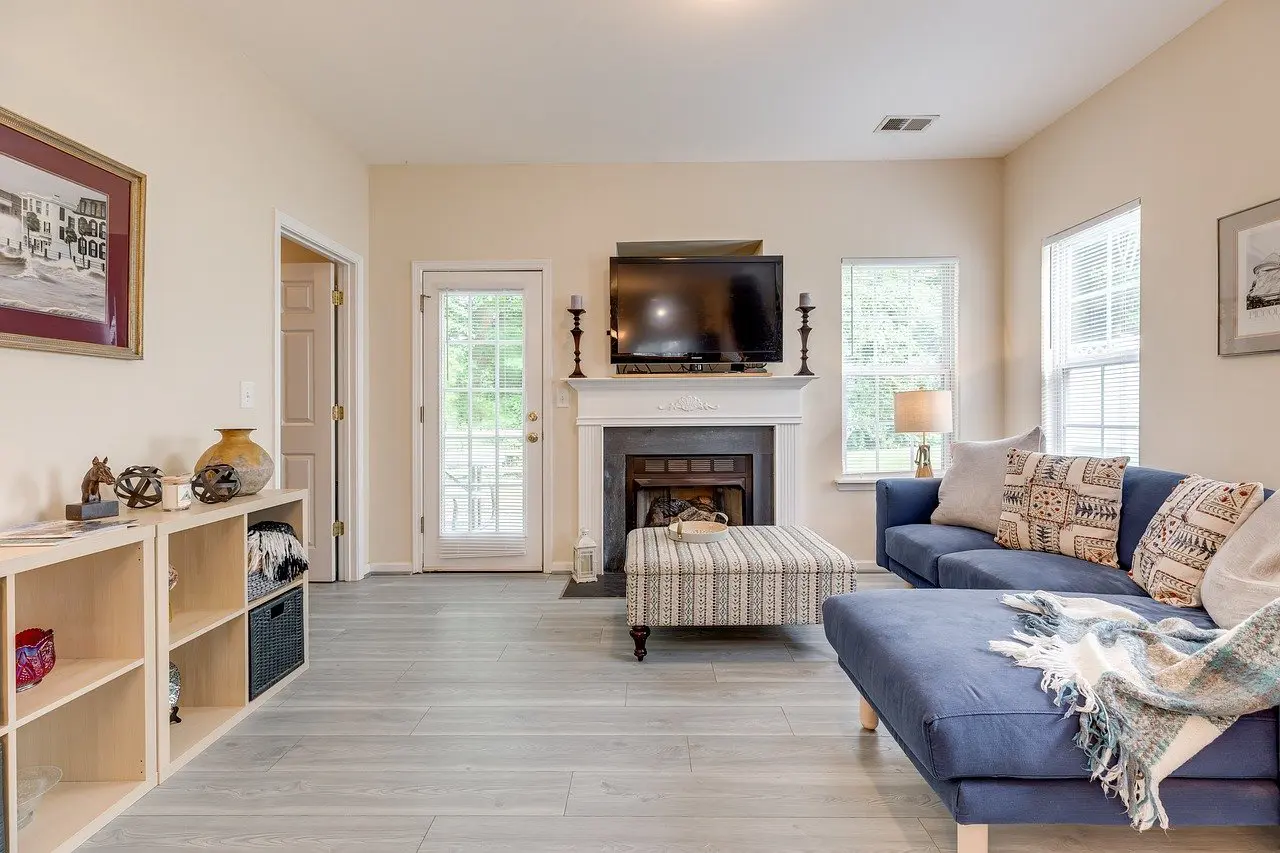 A living room with a fireplace and a television.